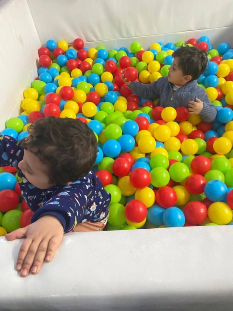Two children playing a ball pit