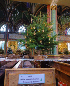 A festive shot of a Christmas tree in a church